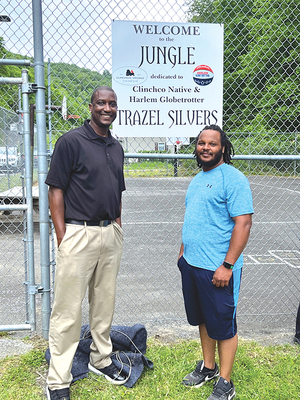 Trazel Silvers and acting Mayor Jelane Mock stand before the basketball court where they often played together as youngsters. The court, called ‘The Jungle,’ is dedicated to the Harlem Globetrotter.  LISA MAINE PHOTO